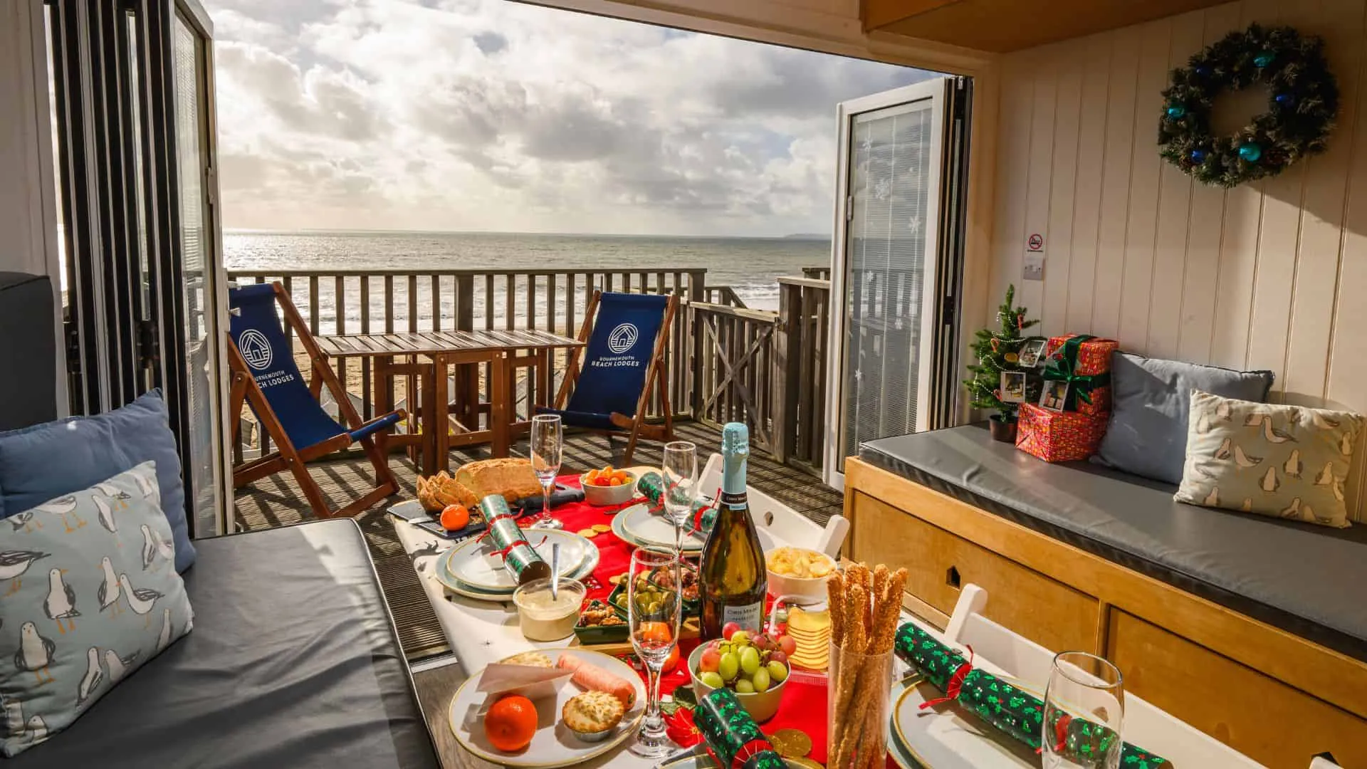 Decorated Christmas table inside Beach Lodge overlooking south facing terrace and the sea