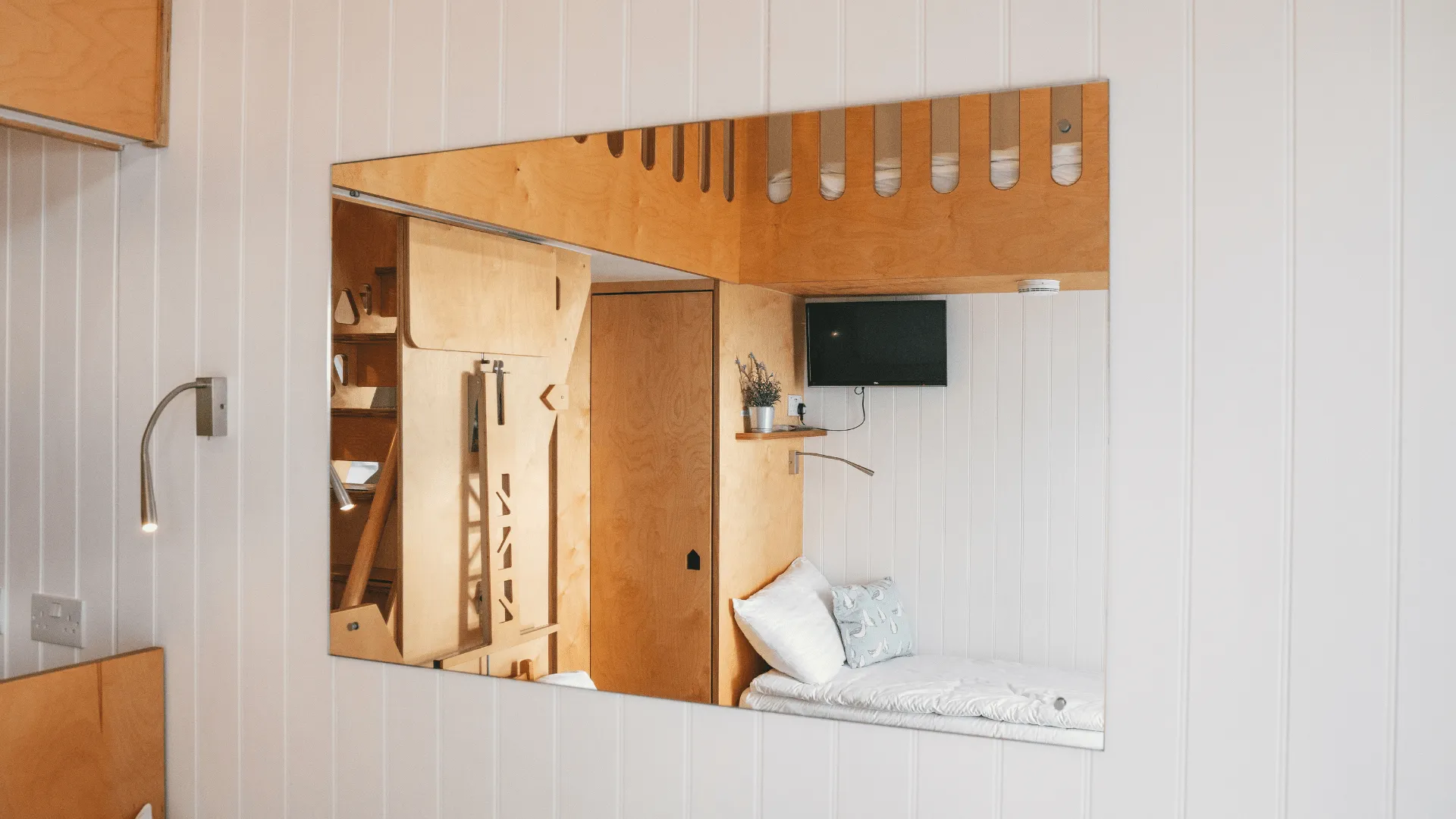 Ground Floor large mirror with TV and bed in reflection