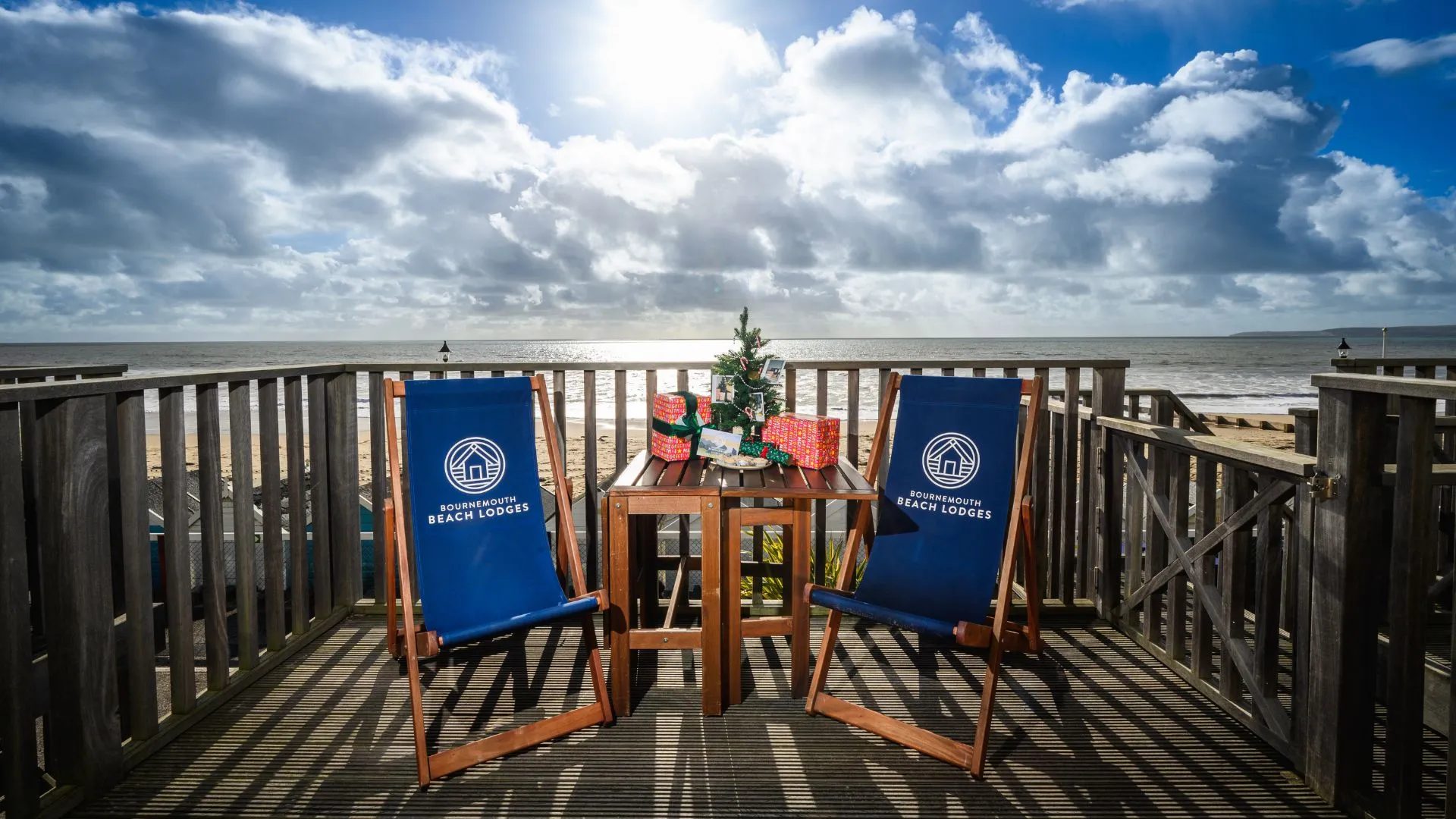Christmas tree and present on terrace table overlooking beautiful beach