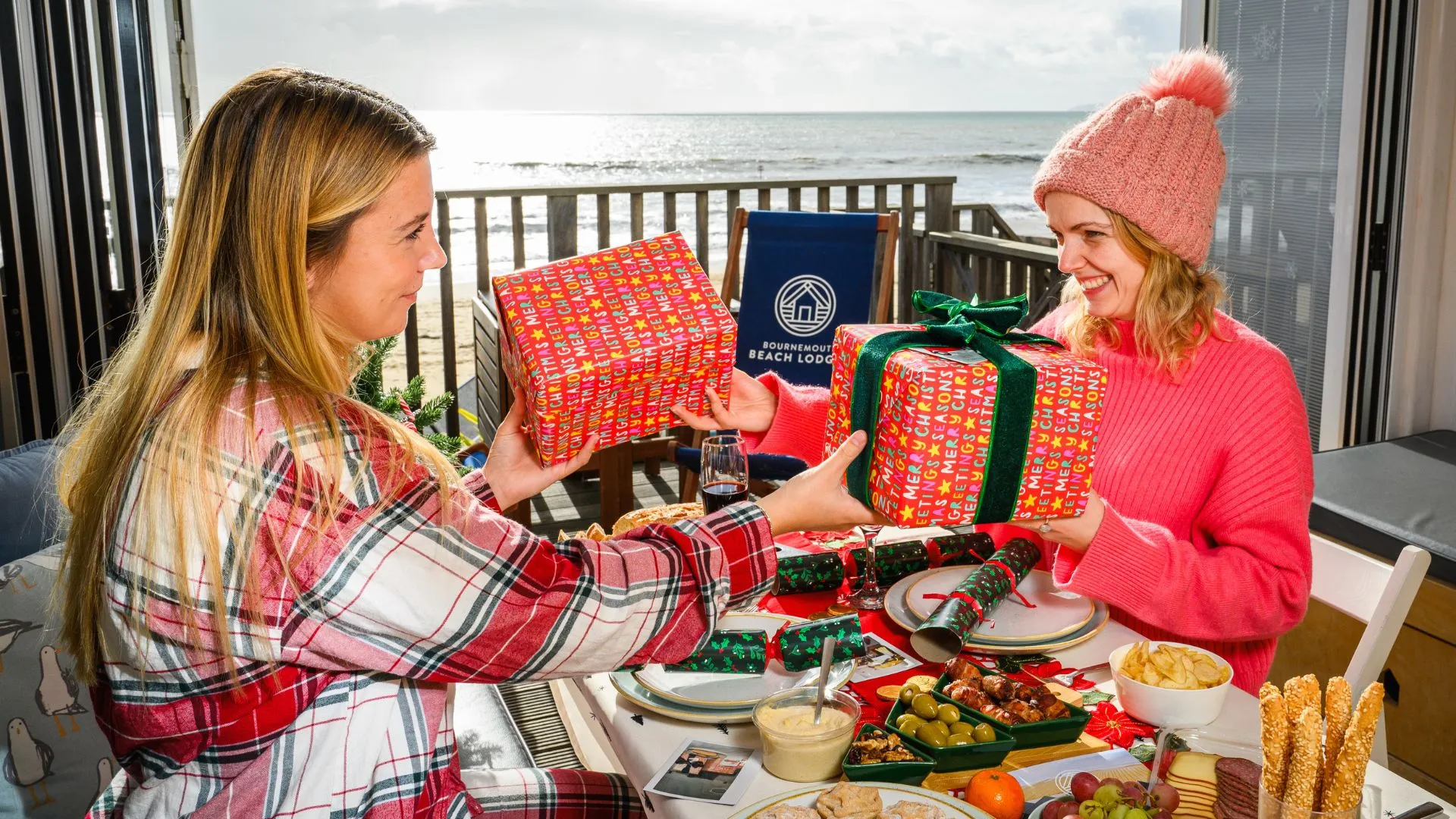 Friends holding presents at the table and exchanging gifts