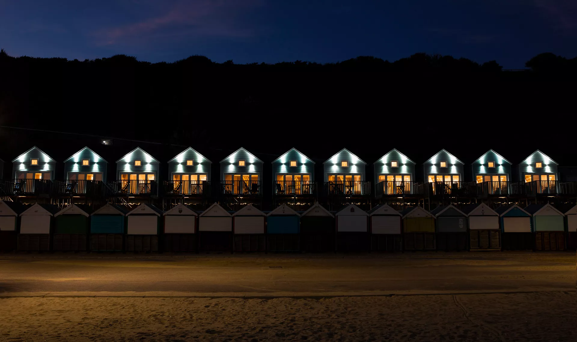 Friends holding wine glasses on south facing deck overlooking beaches
