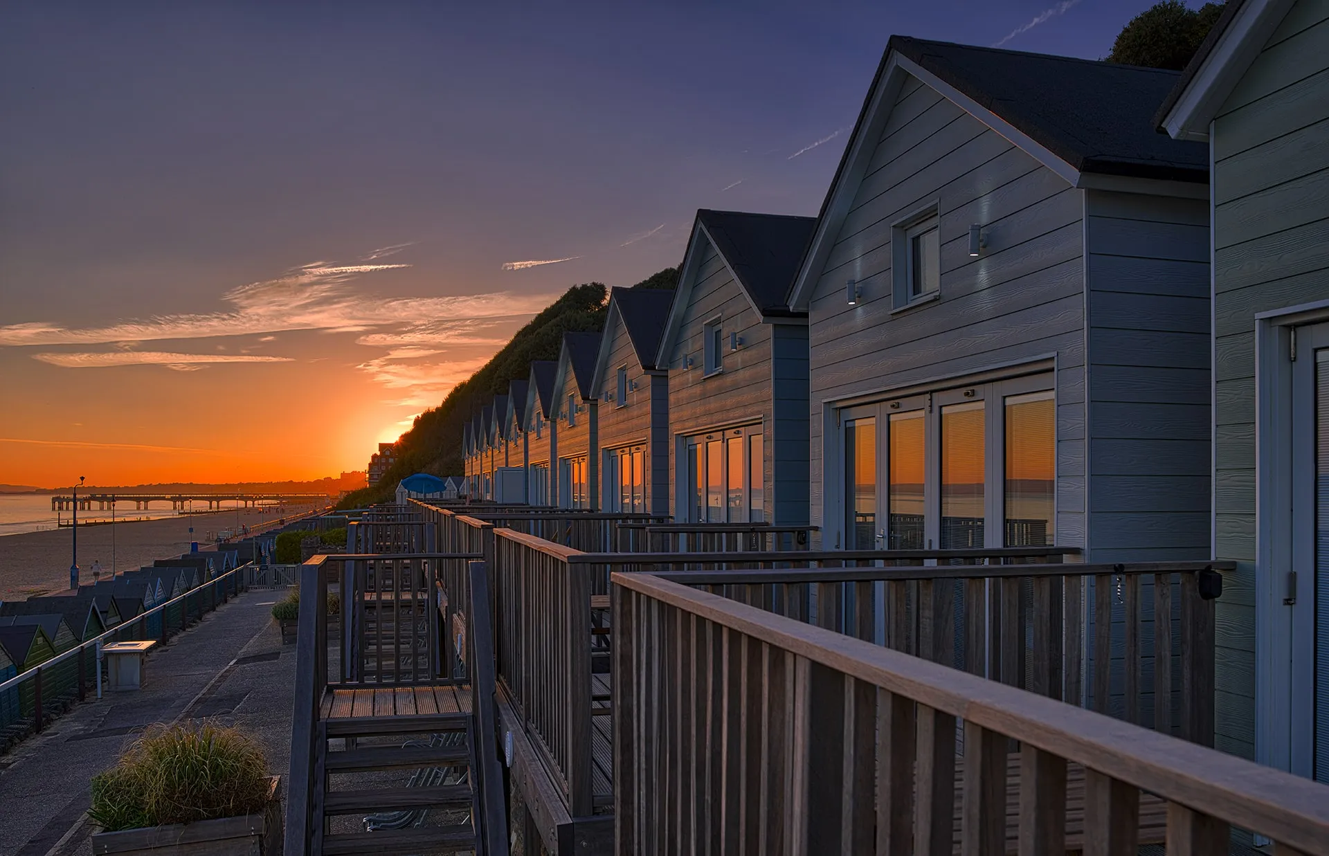 Row of Beach Lodges overlooking glorious sunset towards Boscombe Pier