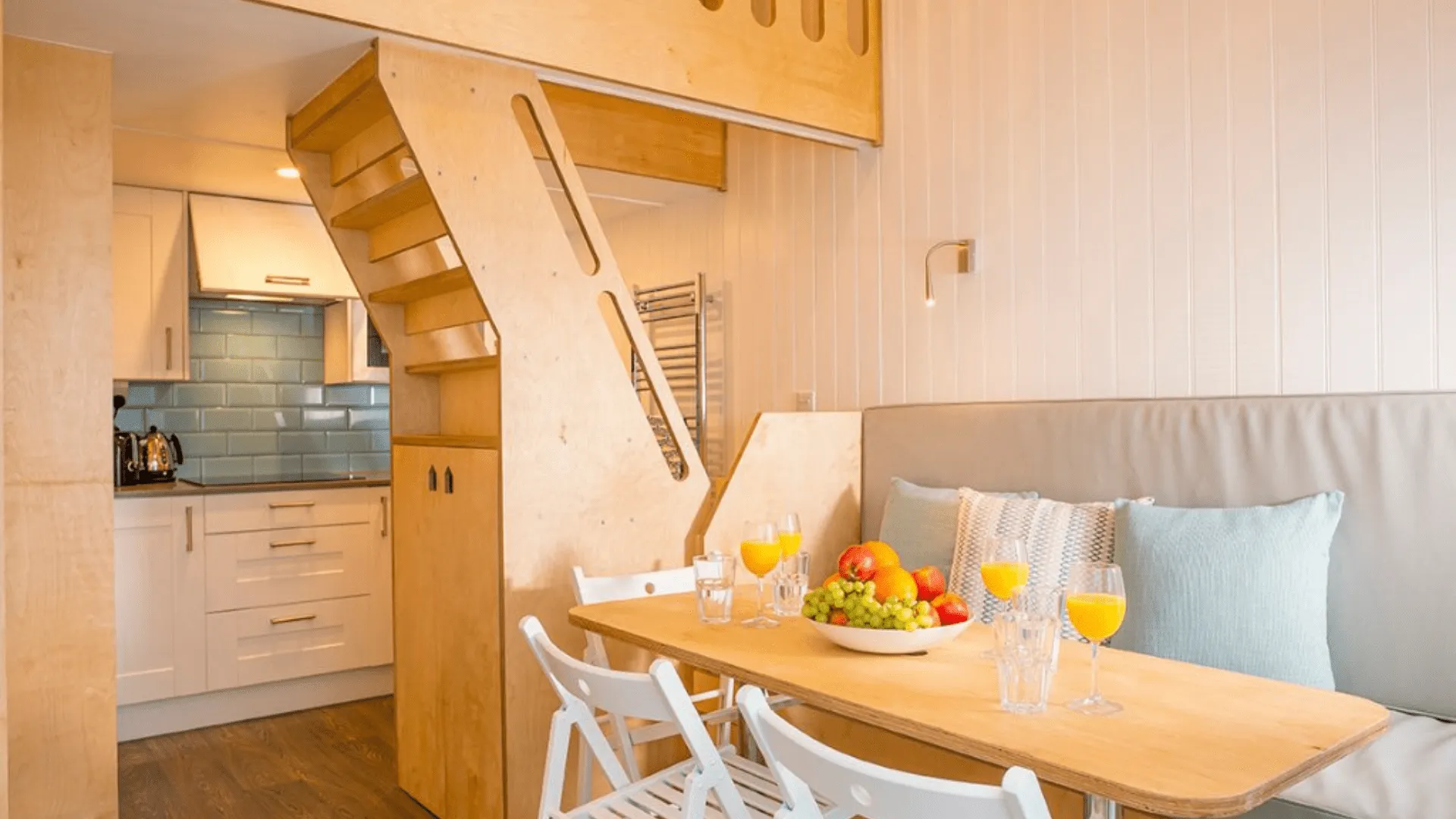 Lodge dining table with food and drink featuring kitchen and staircase
