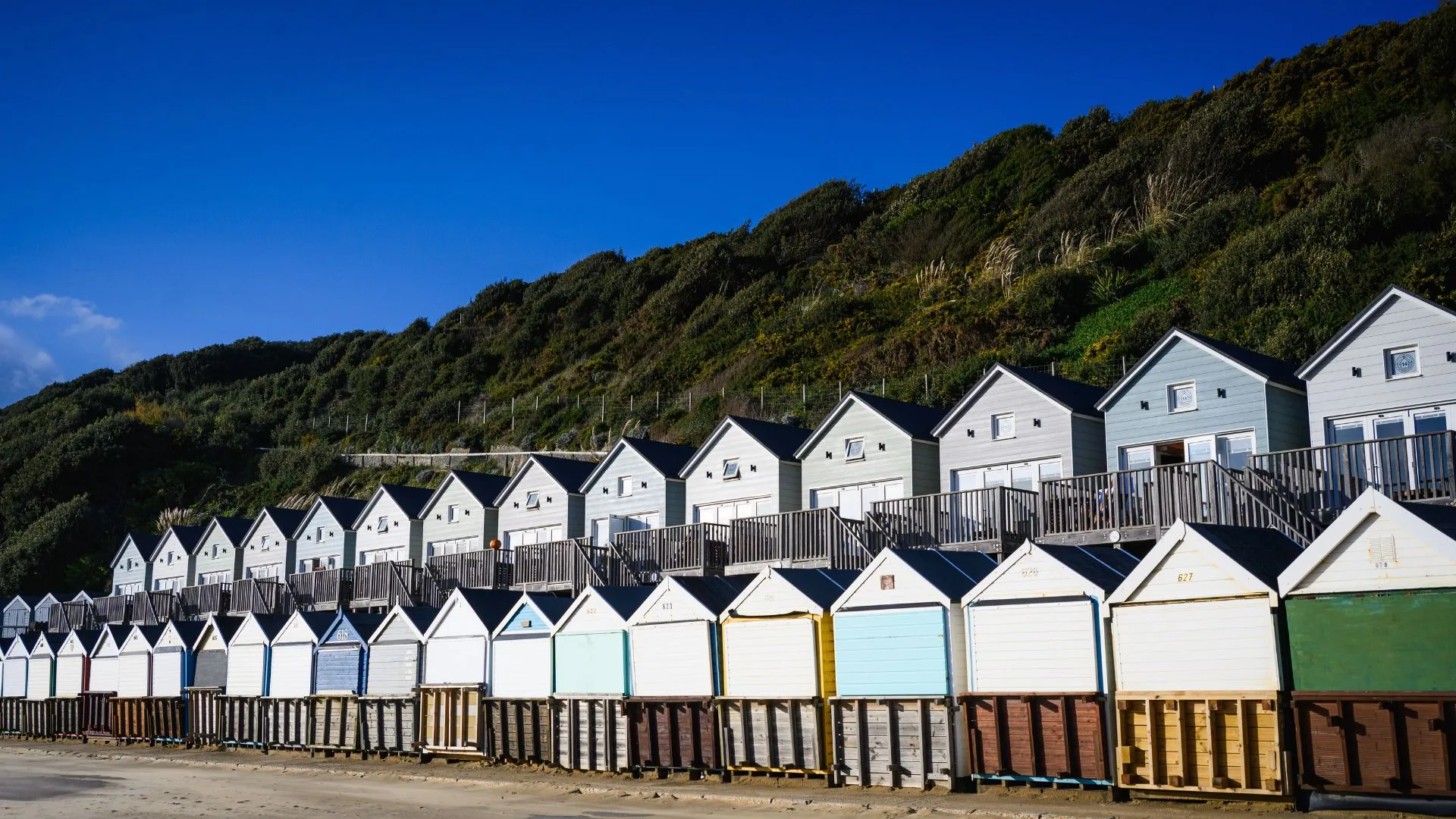Row of Beach Lodges on a bright sunny morning with Manor Steps zig-zag in the background