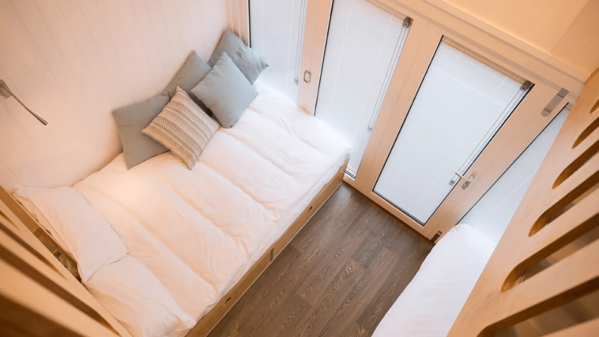 View of ground floor beds and sliding doors from first floor