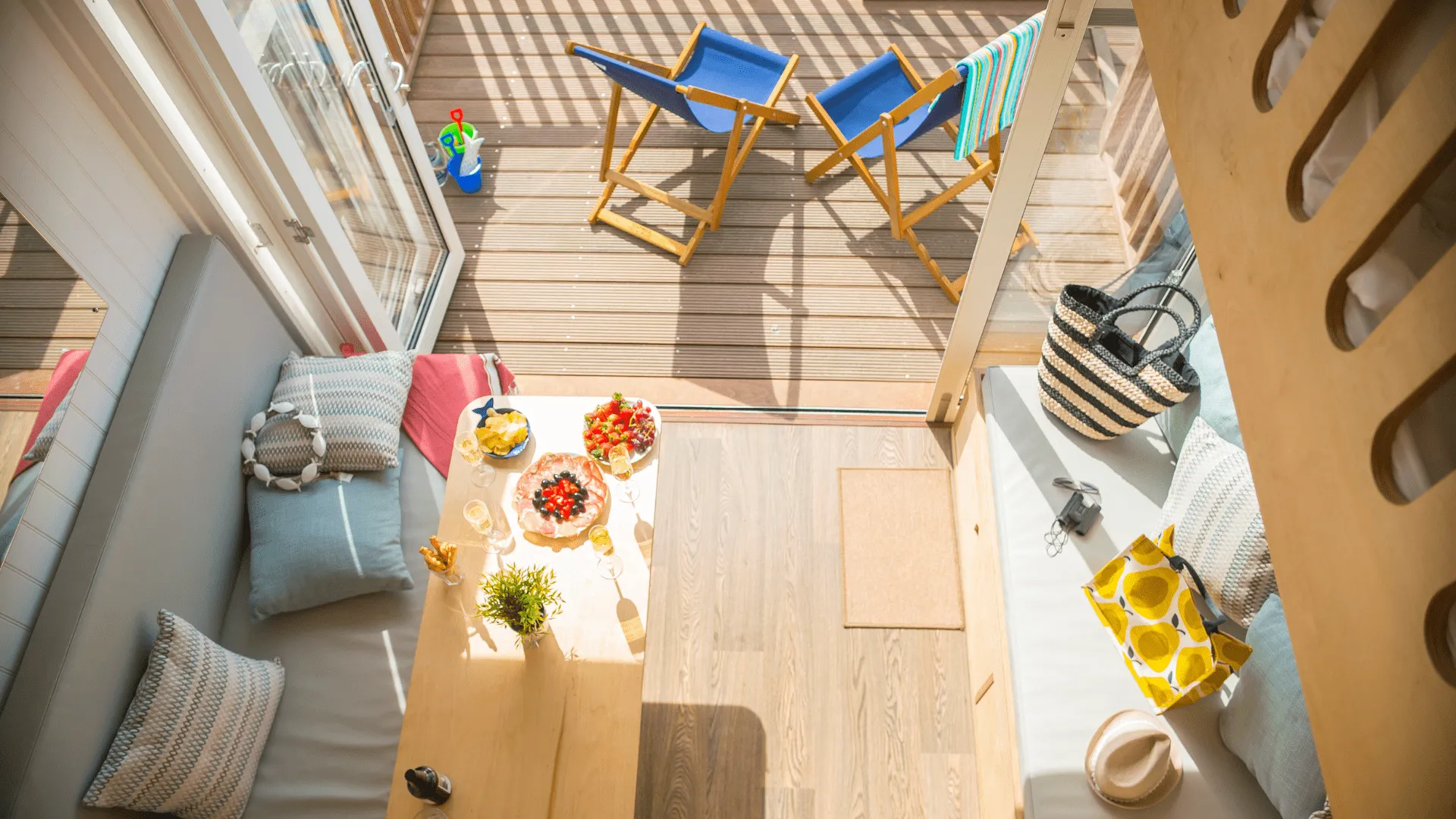 View of downstairs table with food and chairs on a decking