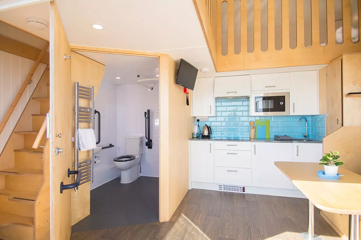 Interior shot of toilet, dining and kitchen area in the accessible beech hut