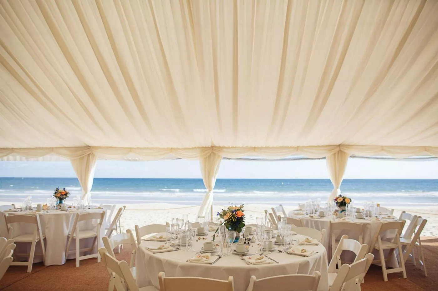 A wedding reception location on the beach.