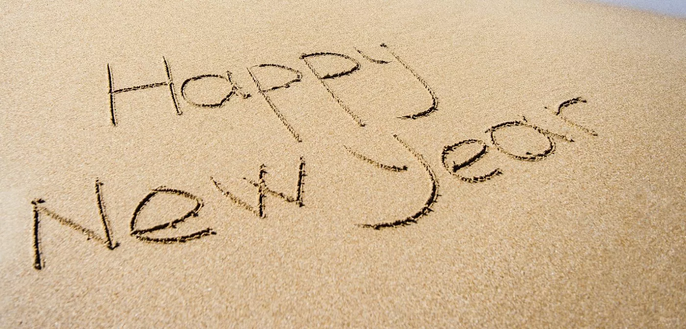 Happy New Year written in the sand on Bournemouth beach