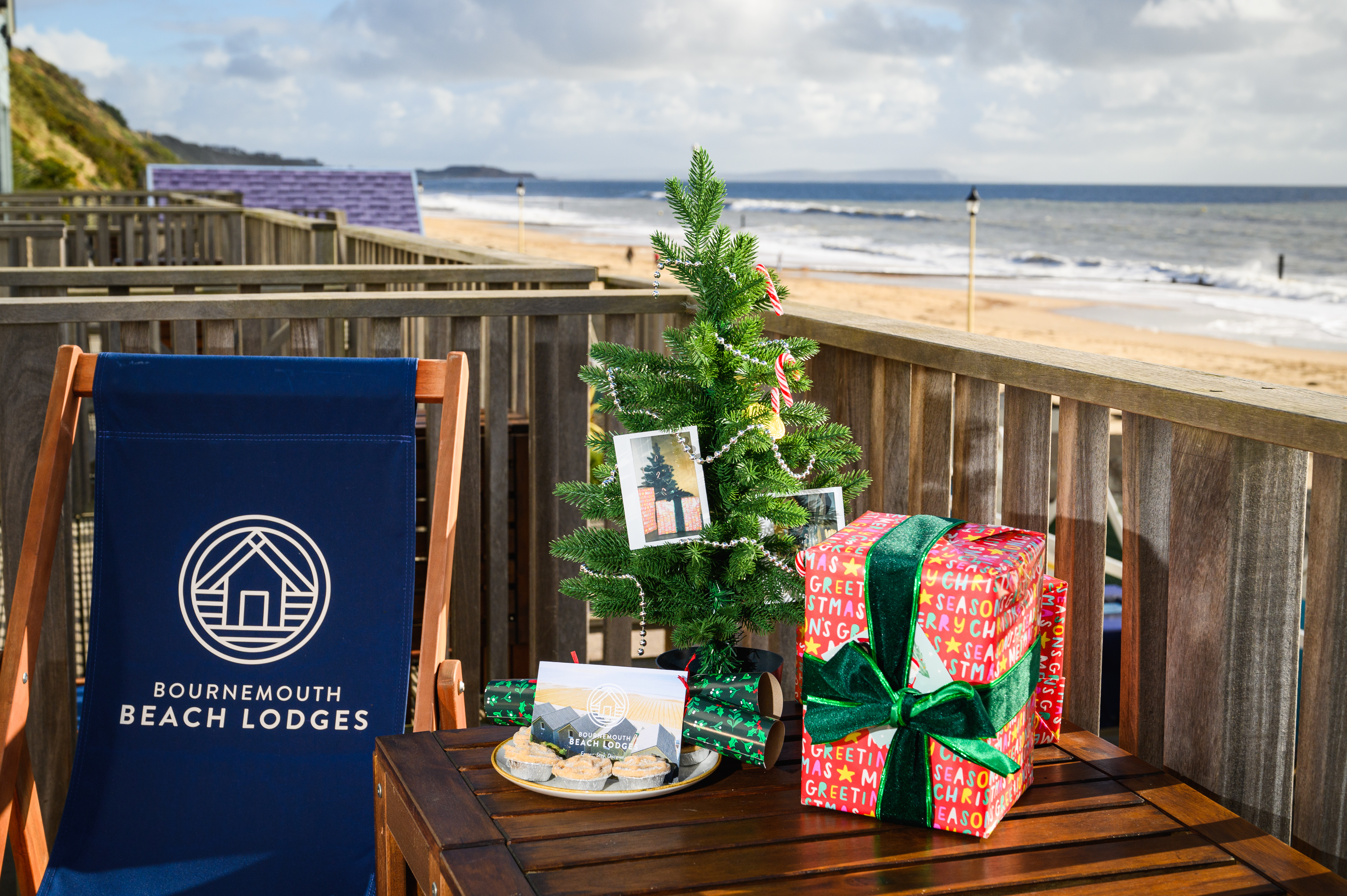 View from the balcony of a beach lodge, with a gift and mini christmas tree on a table