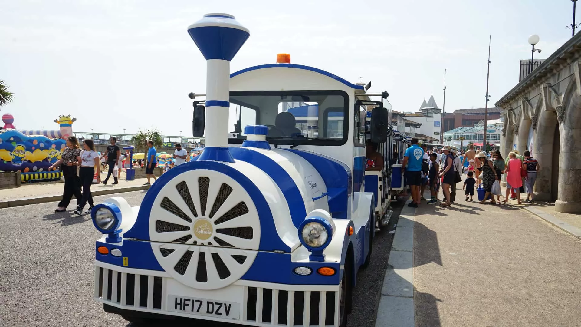 Blue and white land train picking up passengers at Bournemouth Beach
