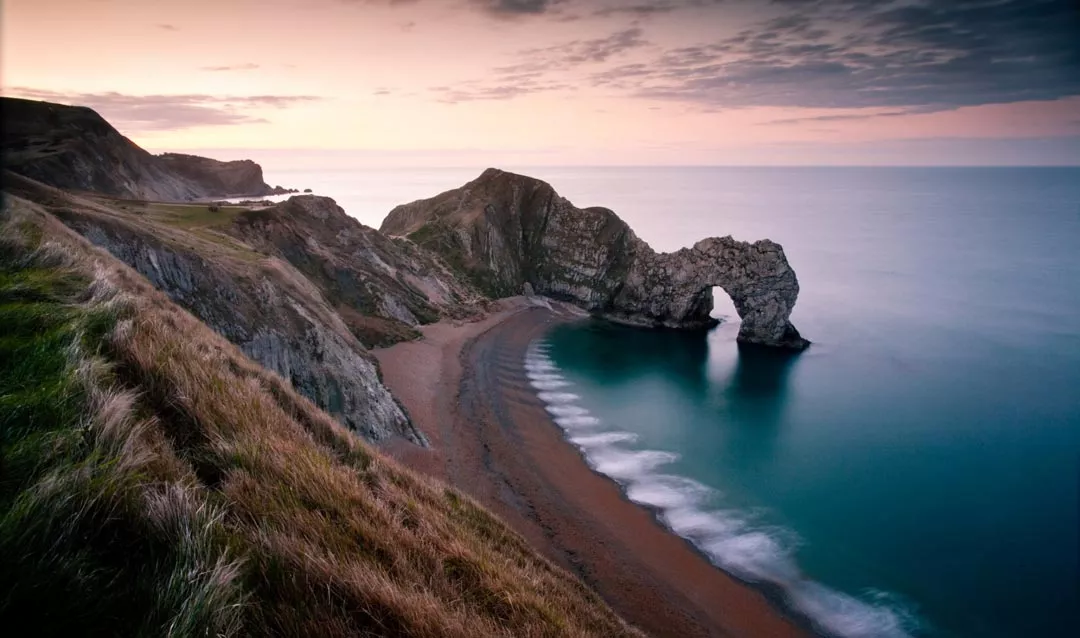 Moody sunset over the Dorset Jurassic coast at Durdle door