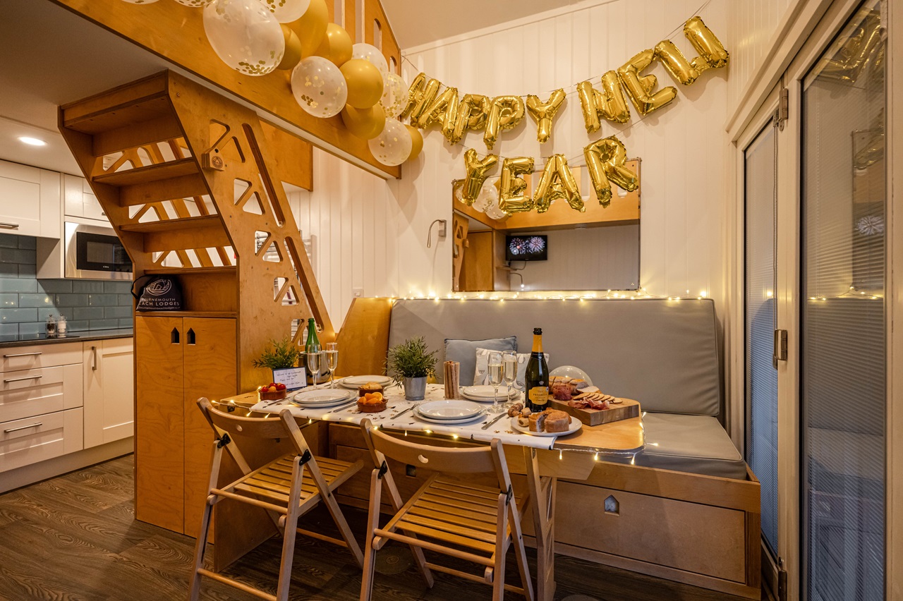 the interior lounge dining area of a beach lodge, decorated for New Year.