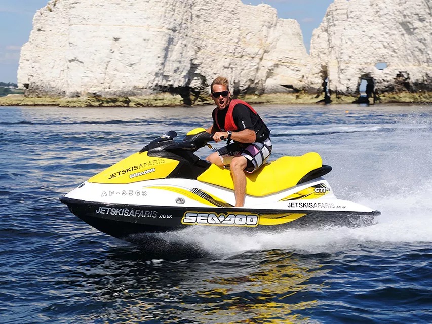 Guy poses for photo while riding his hired jet ski