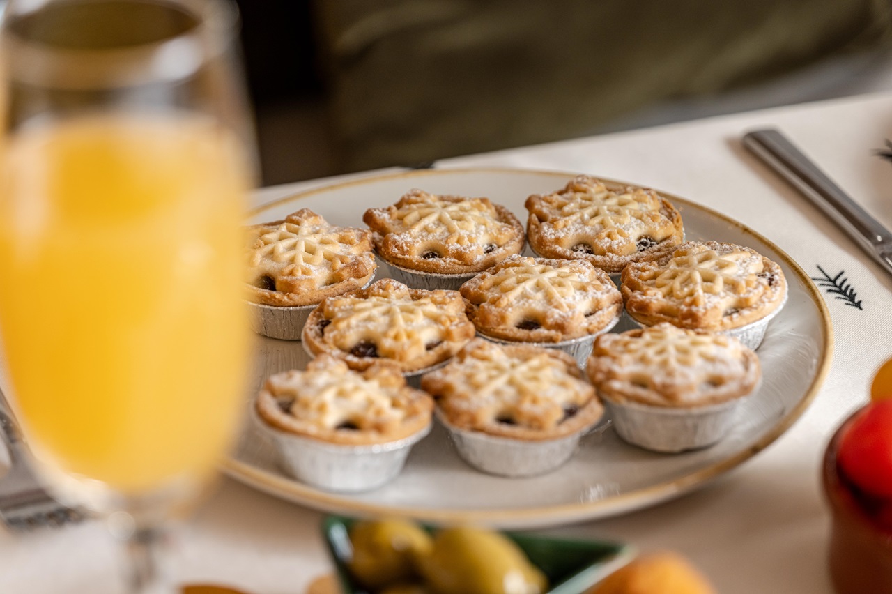 A plate of mince pies on a table.