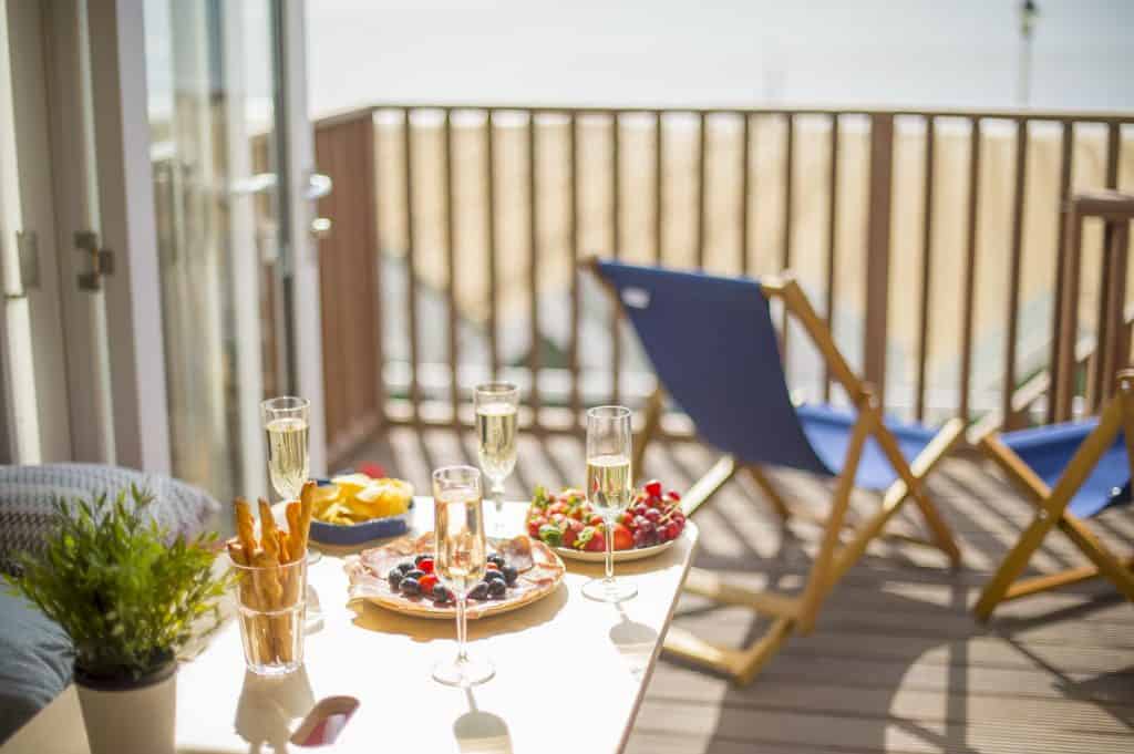 Table set up with food with deck chairs and beach lodge deck in the background