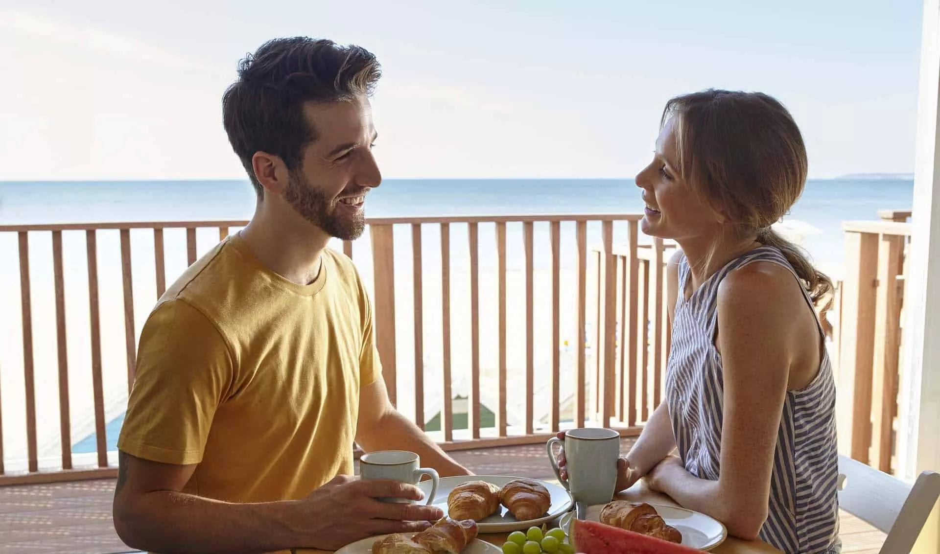 couple eating breakfast with sea view from their Beach Lodge