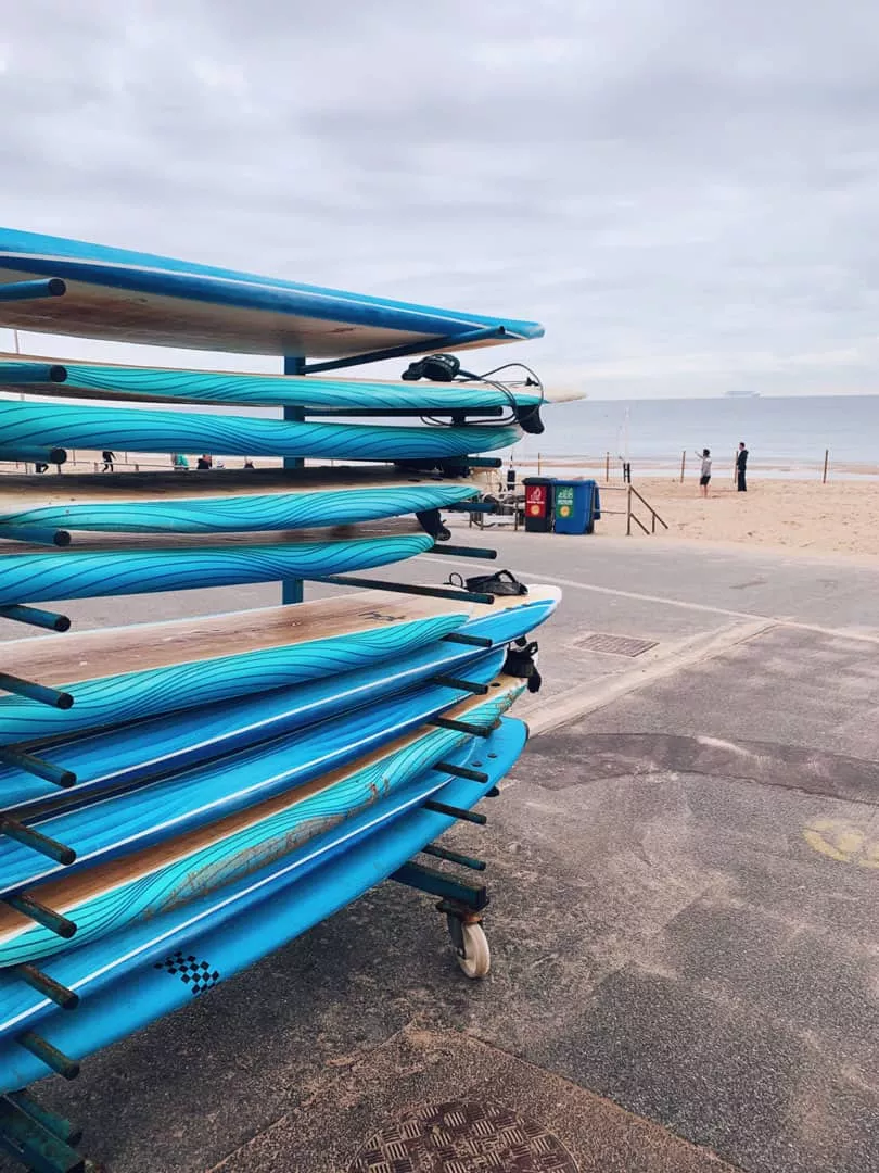 Surf boards racked up next to Bournemouth beach