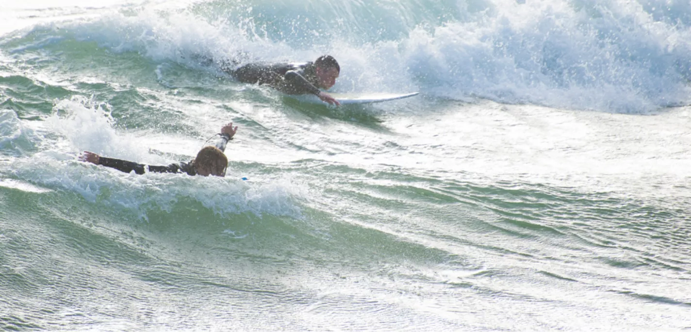 Surfers catching some waves at Boscombe beach